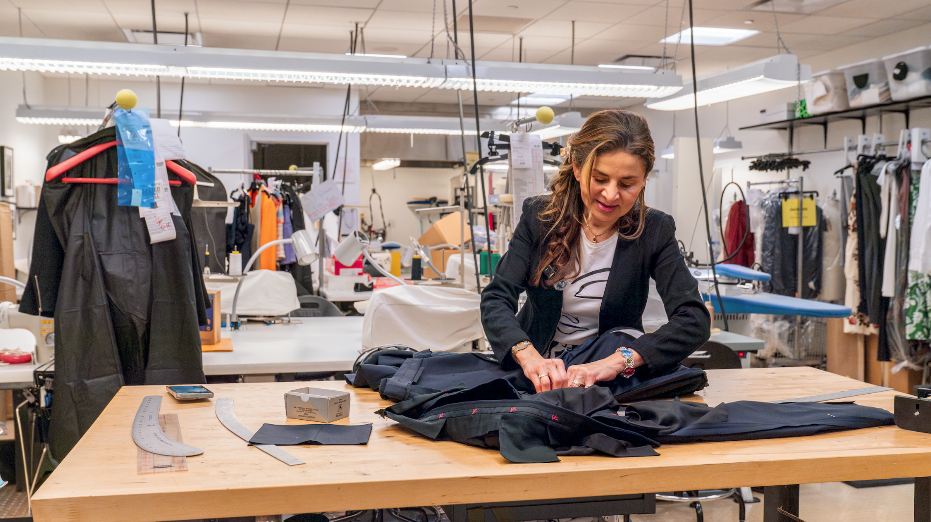 This is a atelier fill with machines and clothes while hilda is working